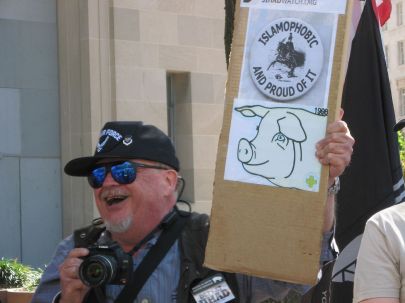 Protester holding a sign in Washington, D.C. Original caption: Sept 15 2007 March and Rally, Member of the counter protest Gathering of Eagles, yelling 